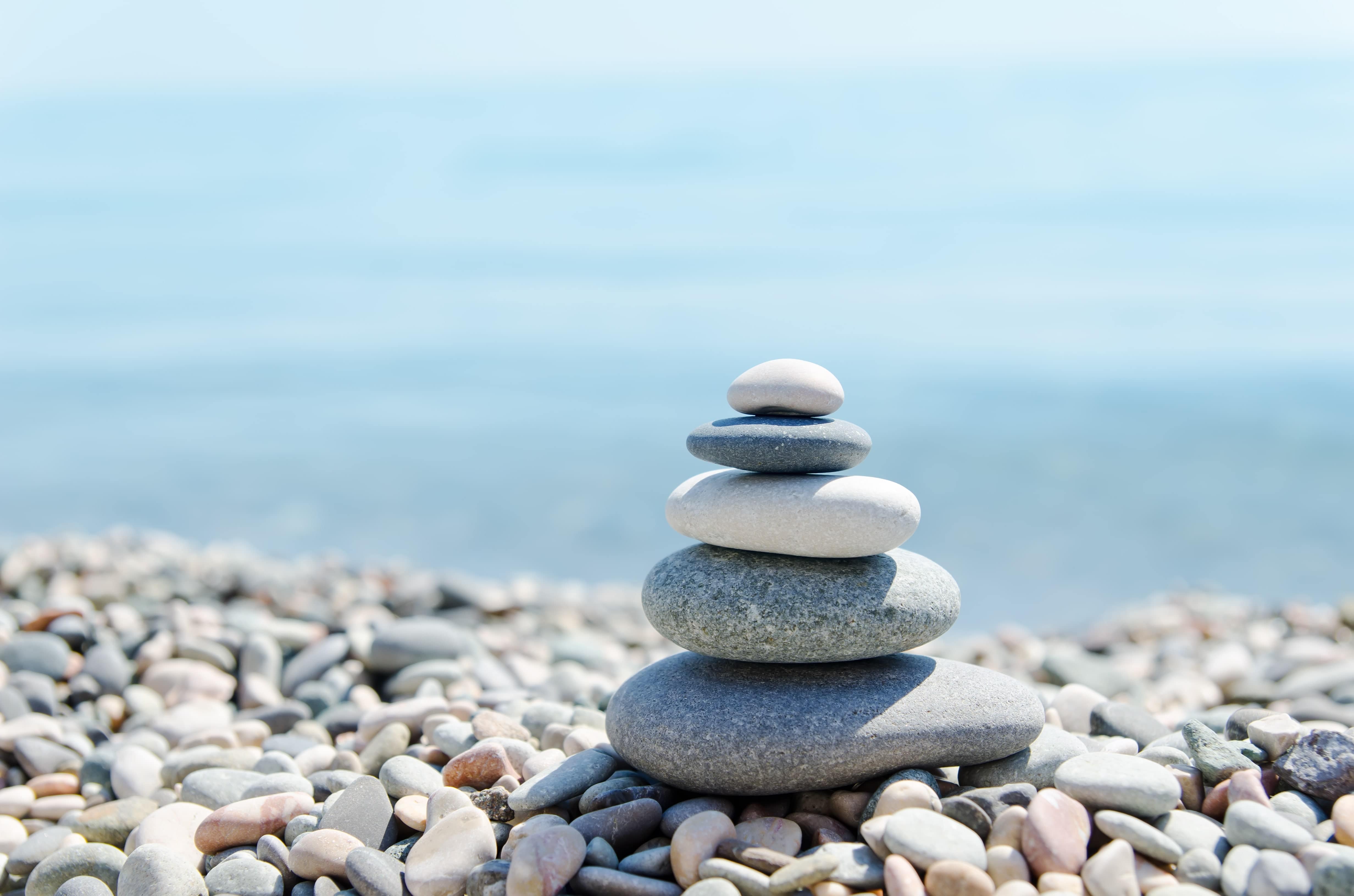 Zen stones for yoga retreats on a pebble beach.