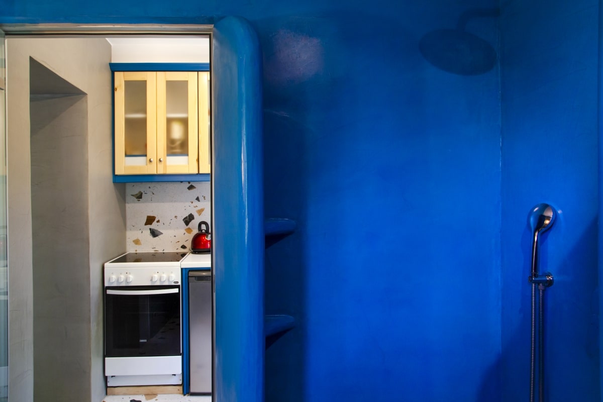 Modern blue shower in the studio's bathroom.