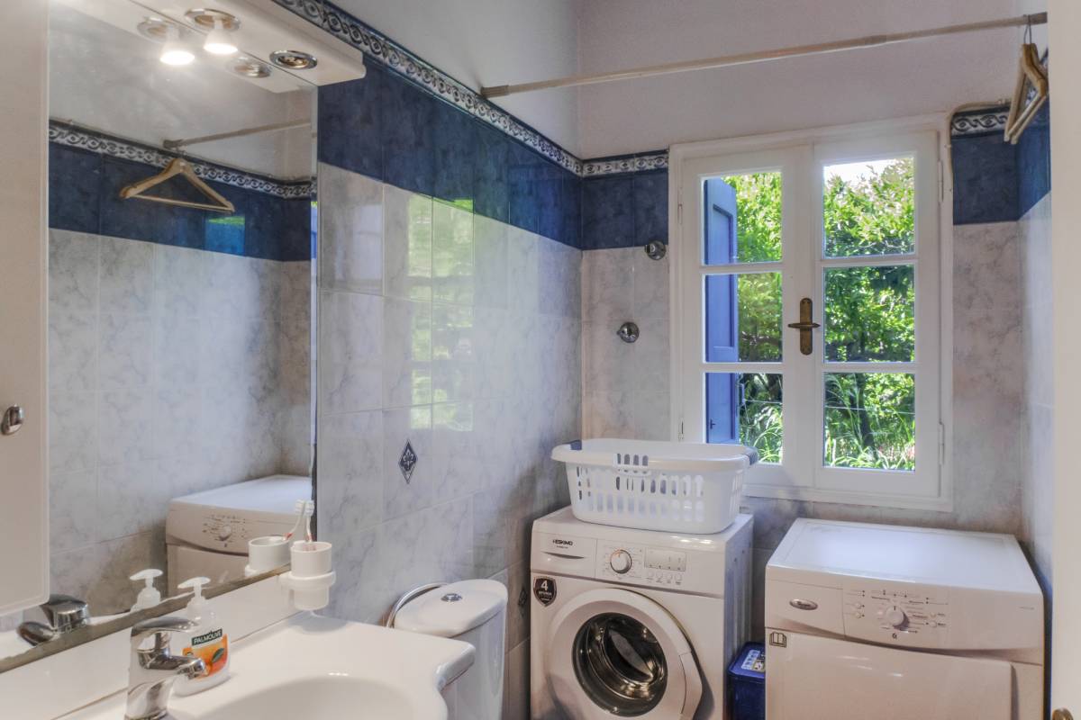 Convenient bathroom with integrated washing machine and dryer.