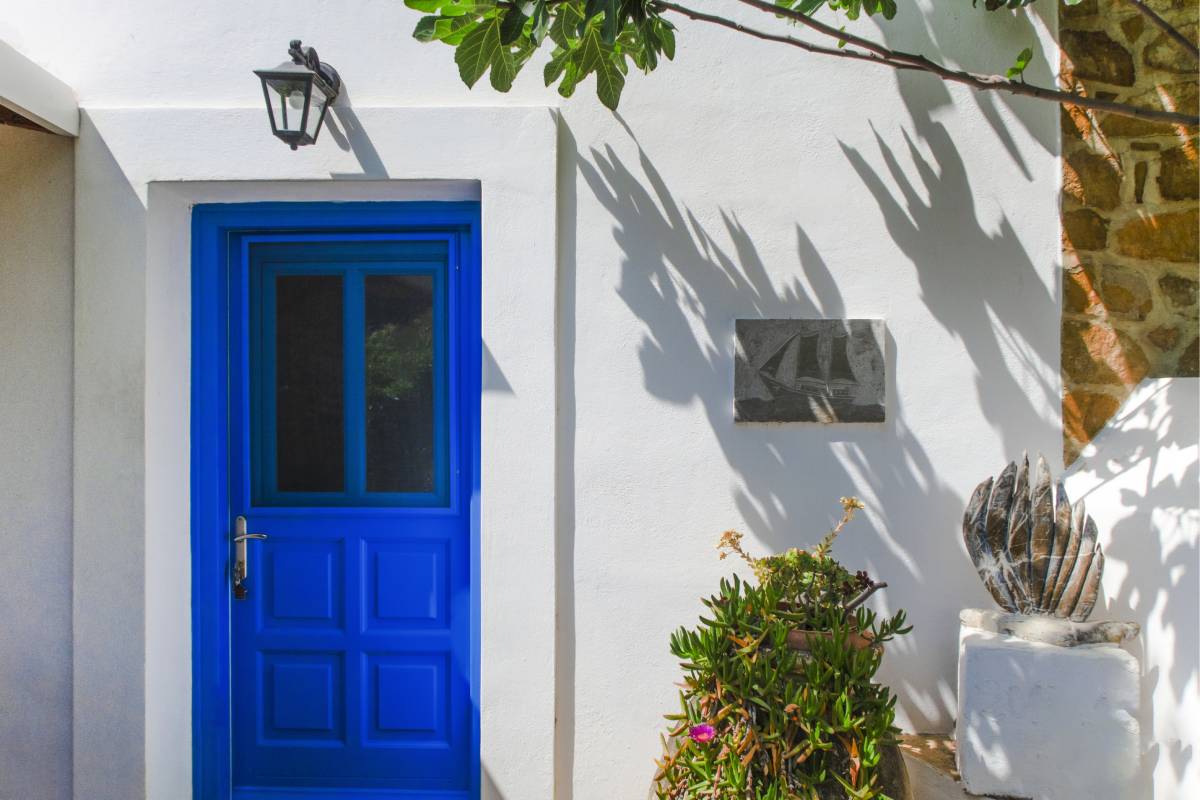 Blue traditional island-style front door of the house.