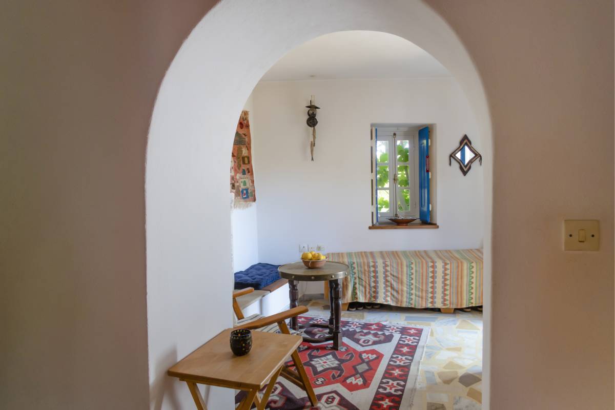 View through an arch doorway showcasing the minimal traditional living room.