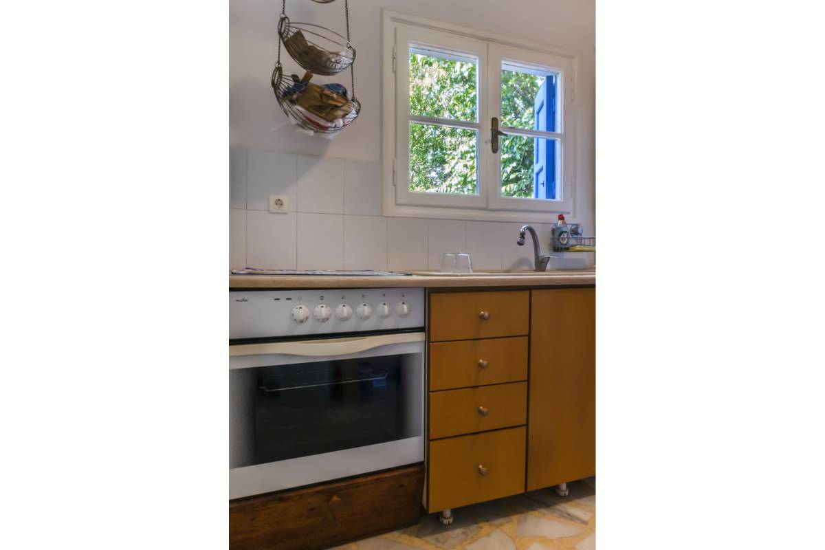 Functional and well-equipped oven and storage cupboards in the kitchen area.